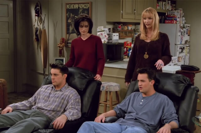 Joey and chandler sitting on reclining chair