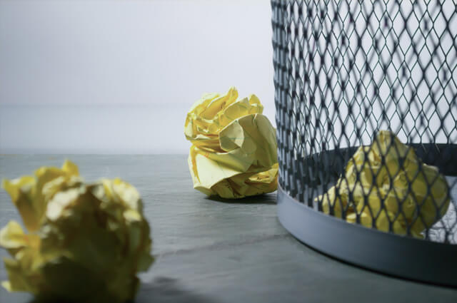 Crumpled paper on trash can